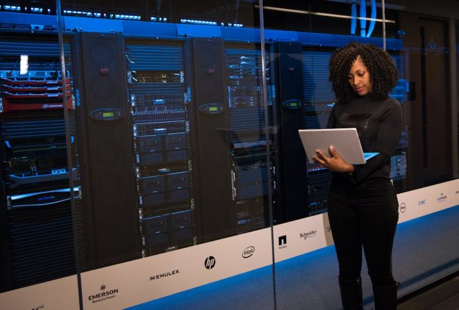 Software Engineer Standing Beside Server Racks