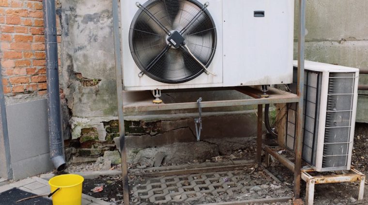 Air conditioner unit near wall of modern building on street