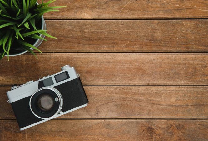 Black and Silver Film Camera on Brown Wooden Surface