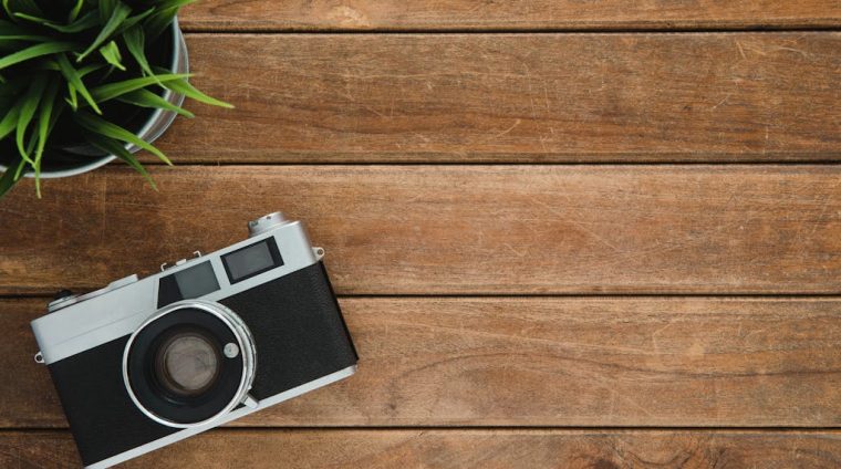 Black and Silver Film Camera on Brown Wooden Surface