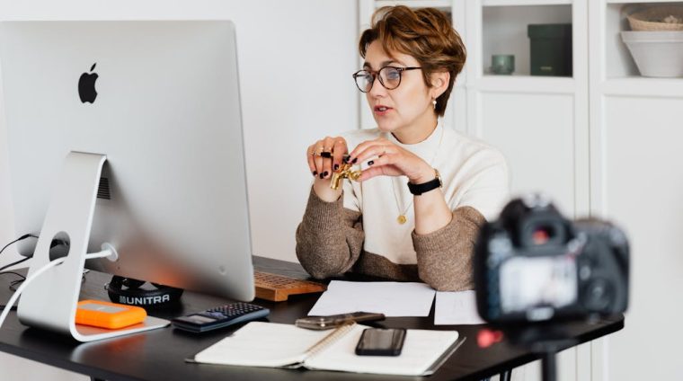 Confident elegant lady in eyeglasses hosting webinar