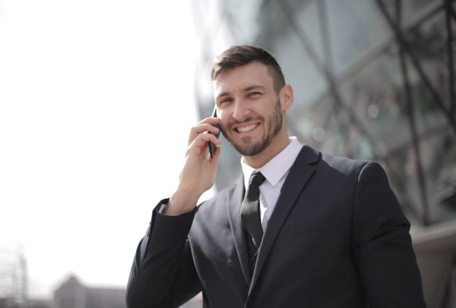 Man in Black Suit Jacket Holding Smartphone