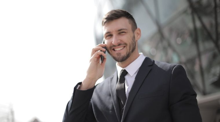 Man in Black Suit Jacket Holding Smartphone