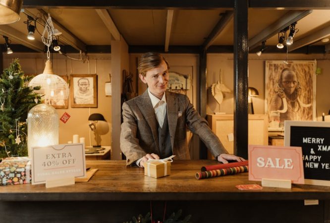 Man in Gray Suit Standing near a Wooden Counter