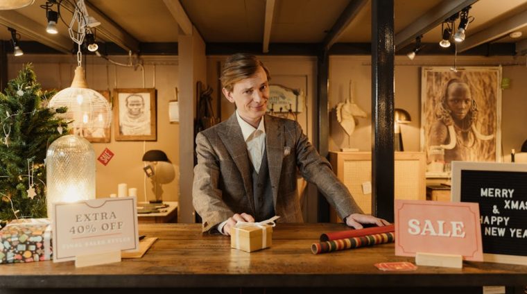 Man in Gray Suit Standing near a Wooden Counter