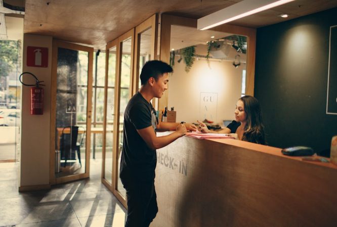 Man Standing in Front of Front Desk