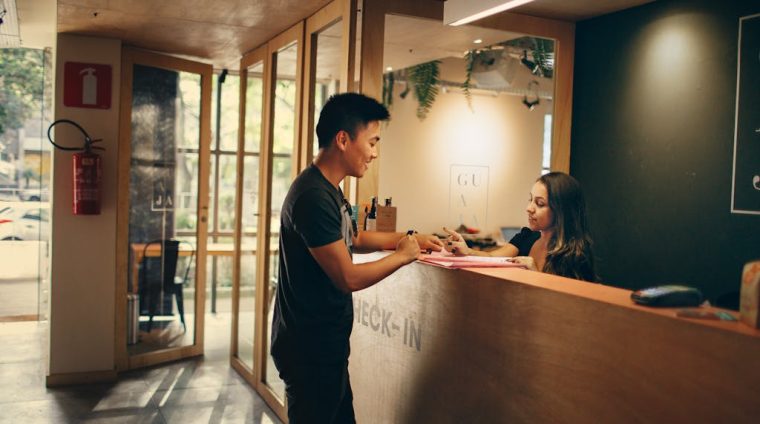 Man Standing in Front of Front Desk