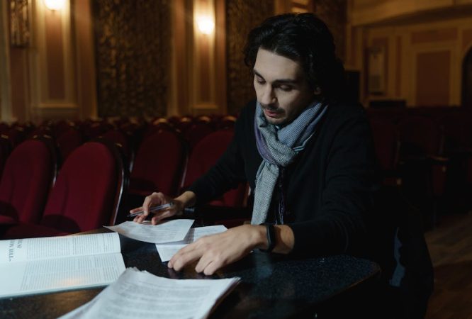 Man Working With Papers Inside A Theathre