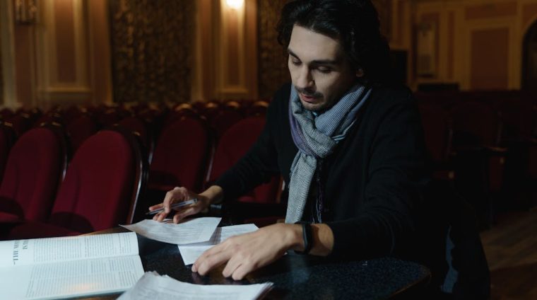 Man Working With Papers Inside A Theathre