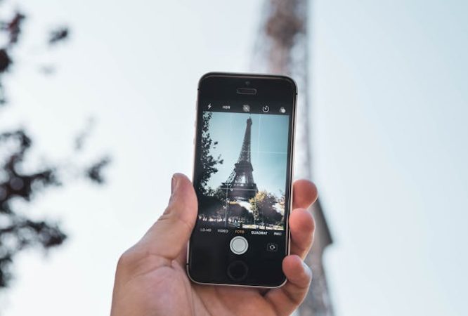 Person Taking Photo of Eiffel Tower