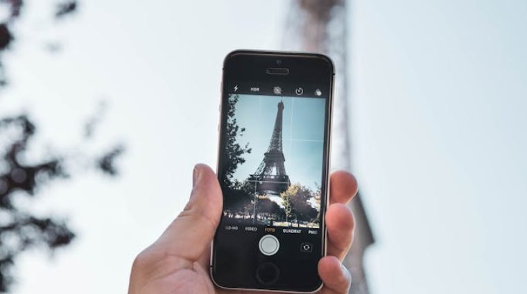 Person Taking Photo of Eiffel Tower