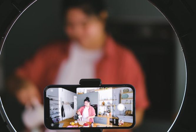 Phone on a Tripod Recording a Woman Cooking 