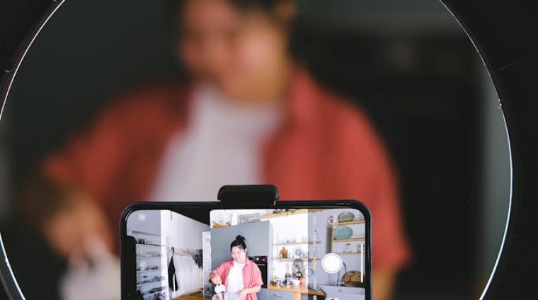 Phone on a Tripod Recording a Woman Cooking 