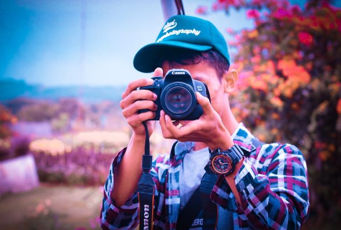 Shallow Focus Photography of a Man Holding Camera