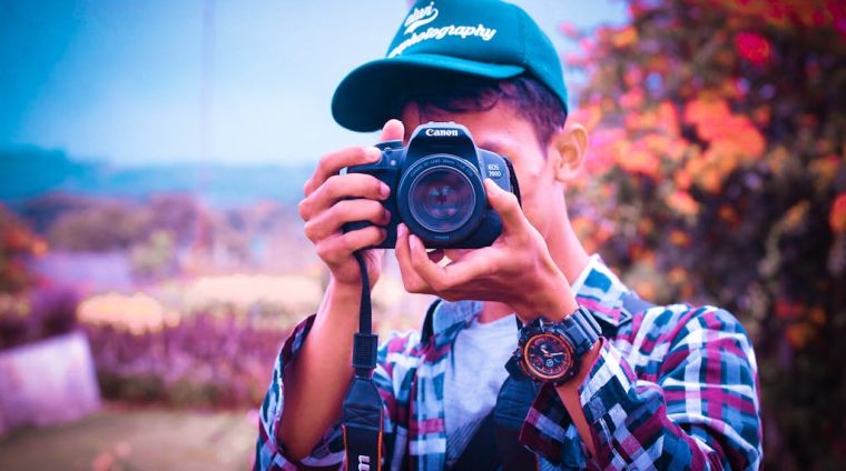 Shallow Focus Photography of a Man Holding Camera