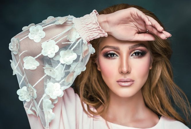 Woman Wearing Floral Long-sleeved Shirt Covering Her Forehead